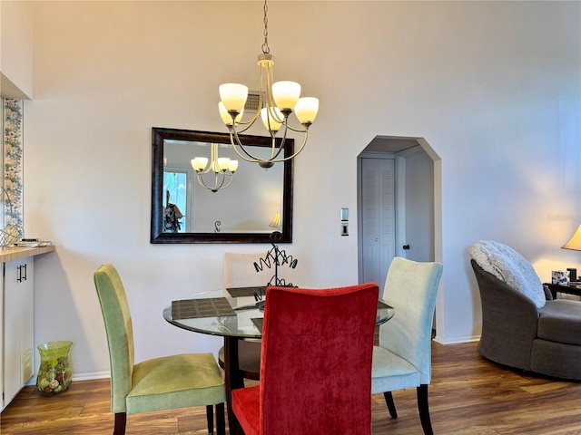 5400 34th St W Unit H12, Bradenton, FL 34210 - dining area with a chandelier, arched walkways, wood finished floors, and a towering ceiling