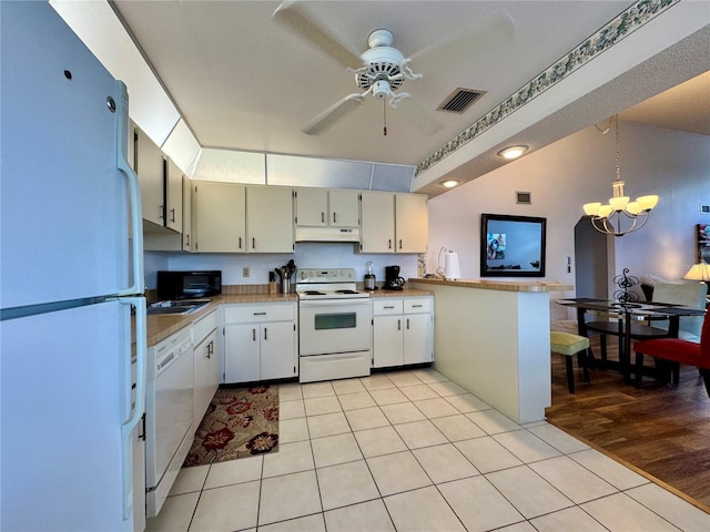 5400 34th St W Unit H12, Bradenton, FL 34210 - kitchen featuring white appliances, under cabinet range hood, a peninsula, ceiling fan, and light tile patterned flooring