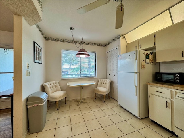 5400 34th St W Unit H12, Bradenton, FL 34210 - kitchen with white appliances, light tile patterned floors, ceiling fan, and hanging light fixtures
