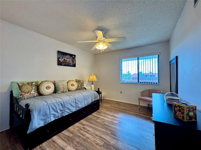 5400 34th St W Unit H12, Bradenton, FL 34210 - bedroom with a textured ceiling, wood finished floors, and ceiling fan