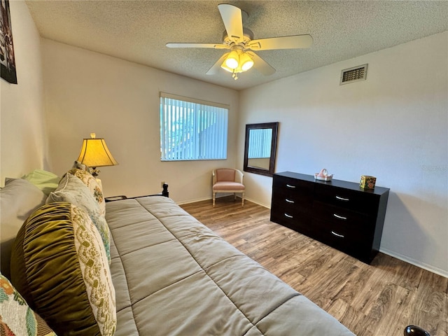 5400 34th St W Unit H12, Bradenton, FL 34210 - living room with a textured ceiling, wood finished floors, and a ceiling fan