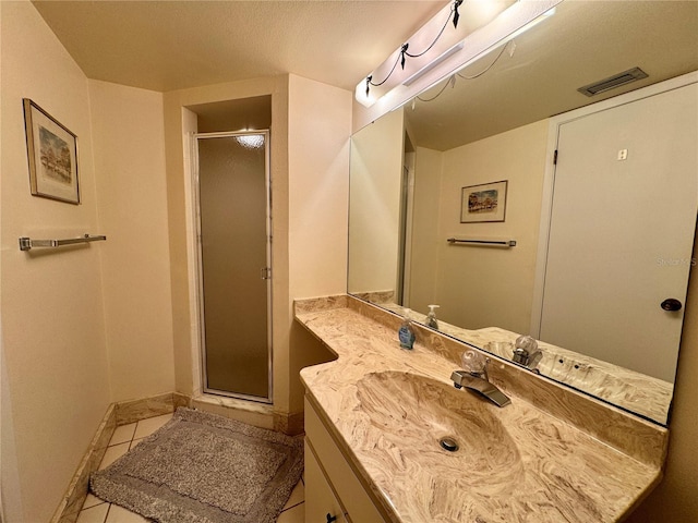 5400 34th St W Unit H12, Bradenton, FL 34210 - bathroom with vanity, a stall shower, and tile patterned floors