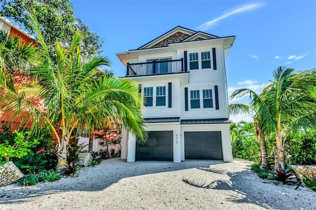 5219 Calle Menorca, Sarasota, FL 34242 - beach home with a balcony, a garage, a standing seam roof, driveway, and metal roof