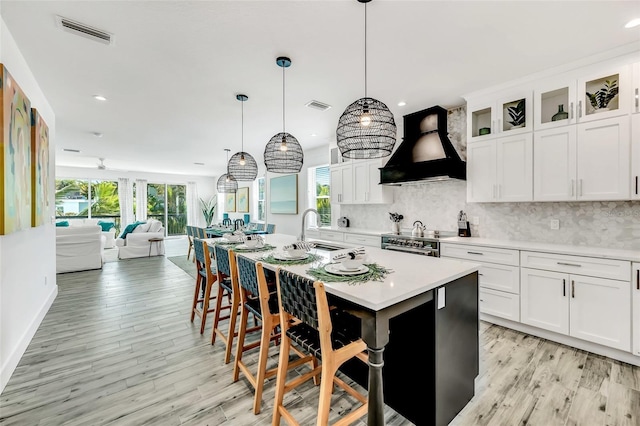 5219 Calle Menorca, Sarasota, FL 34242 - kitchen featuring custom exhaust hood, a sink, light countertops, decorative backsplash, and recessed lighting