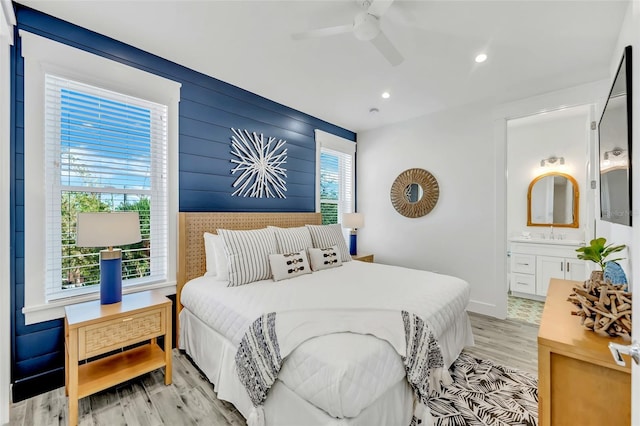 5219 Calle Menorca, Sarasota, FL 34242 - bedroom with light wood-style floors, recessed lighting, ensuite bathroom, ceiling fan, and a sink