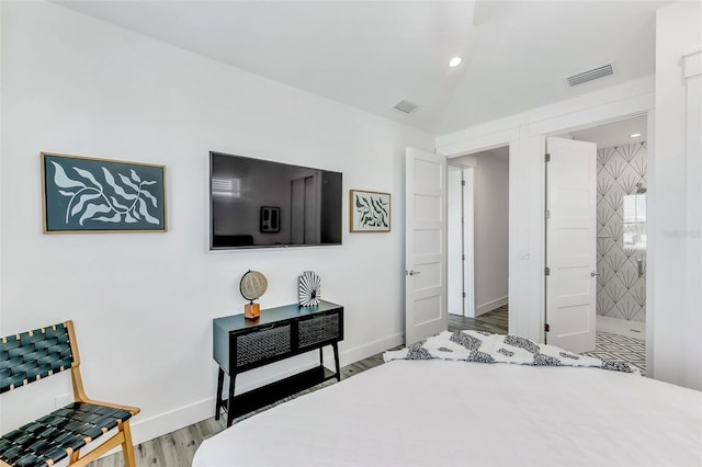 5219 Calle Menorca, Sarasota, FL 34242 - bedroom with wood finished floors, baseboards, recessed lighting, and ensuite bathroom