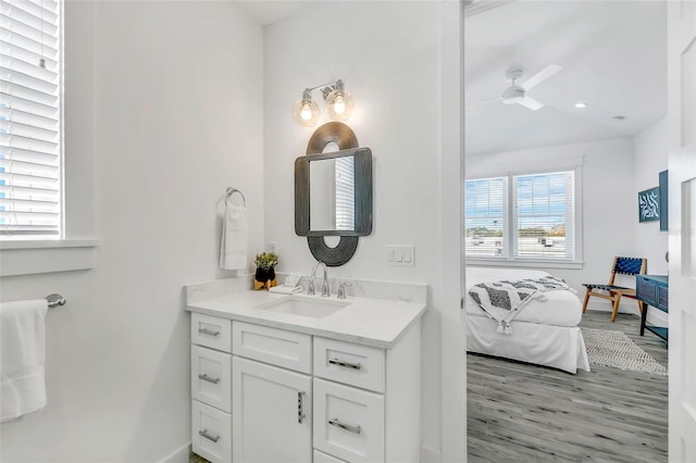 5219 Calle Menorca, Sarasota, FL 34242 - bathroom with vanity, wood finished floors, ensuite bathroom, ceiling fan, and baseboards