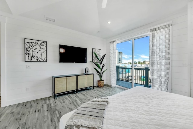 5219 Calle Menorca, Sarasota, FL 34242 - bedroom with access to exterior, wood finished floors, recessed lighting, and wooden walls