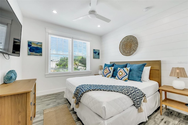 5219 Calle Menorca, Sarasota, FL 34242 - bedroom featuring baseboards, light wood-style flooring, recessed lighting, a ceiling fan, and wooden walls