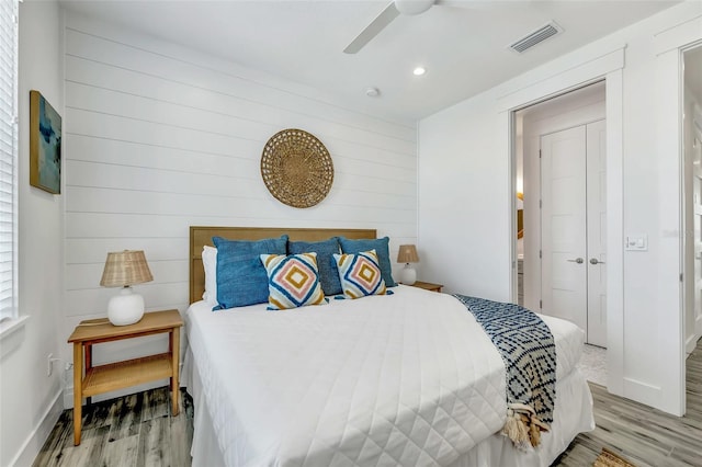 5219 Calle Menorca, Sarasota, FL 34242 - bedroom with light wood finished floors, recessed lighting, a ceiling fan, baseboards, and wood walls