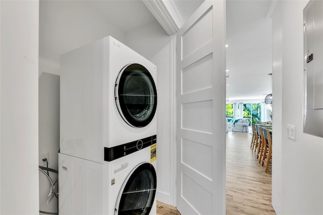 5219 Calle Menorca, Sarasota, FL 34242 - laundry area featuring estacked washer and dryer and light wood finished floors