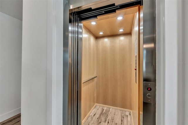 5219 Calle Menorca, Sarasota, FL 34242 - elevator featuring wood finished floors, recessed lighting, and baseboards