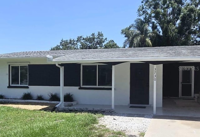 3730 Ferguson St, Sarasota, FL 34233 - property entrance featuring roof with shingles
