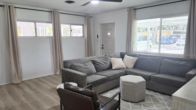 3730 Ferguson St, Sarasota, FL 34233 - living room with ceiling fan, healthy amount of natural light, light wood-style floors, and baseboards
