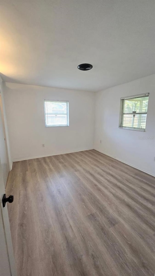 3730 Ferguson St, Sarasota, FL 34233 - unfurnished room with plenty of natural light and wood finished floors