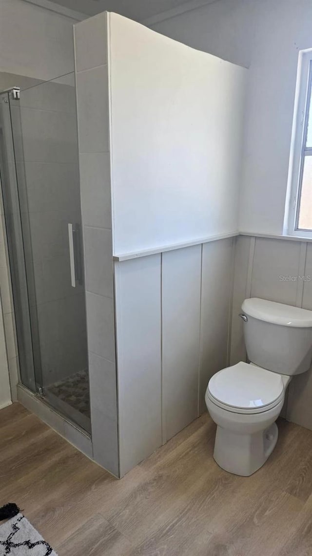 3730 Ferguson St, Sarasota, FL 34233 - full bathroom with wood finished floors, a shower stall, and toilet