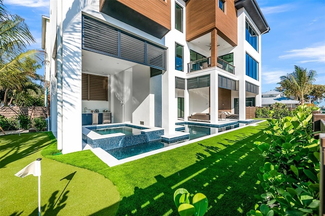 100 6th St S, Bradenton Beach, FL 34217 - back of property with a balcony, stucco siding, a patio, a pool with connected hot tub, and an outdoor kitchen
