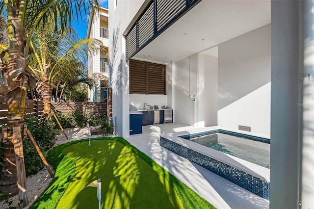 100 6th St S, Bradenton Beach, FL 34217 - view of swimming pool with an outdoor kitchen, a hot tub, an area to practice putting, and a patio