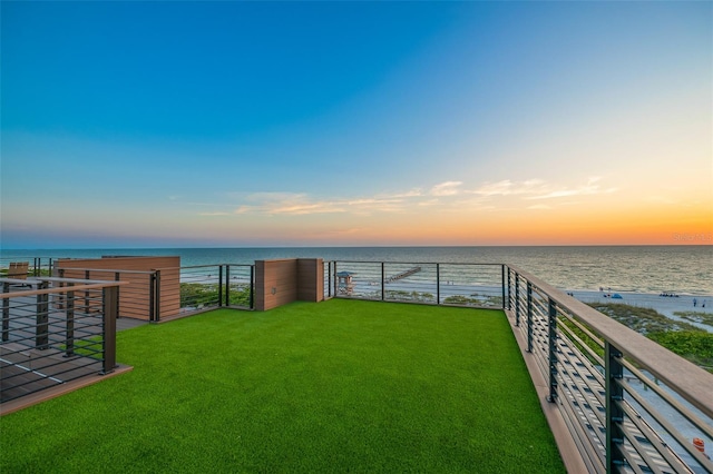 100 6th St S, Bradenton Beach, FL 34217 - yard at dusk featuring a water view and a yard