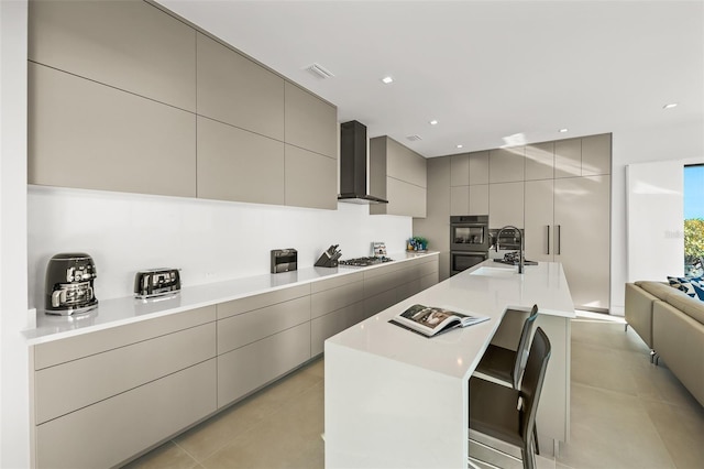 100 6th St S, Bradenton Beach, FL 34217 - kitchen featuring wall chimney exhaust hood, gray cabinets, stainless steel appliances, modern cabinets, and a sink