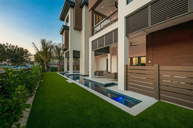 100 6th St S, Bradenton Beach, FL 34217 - view of yard featuring ceiling fan, a balcony, and an outdoor pool