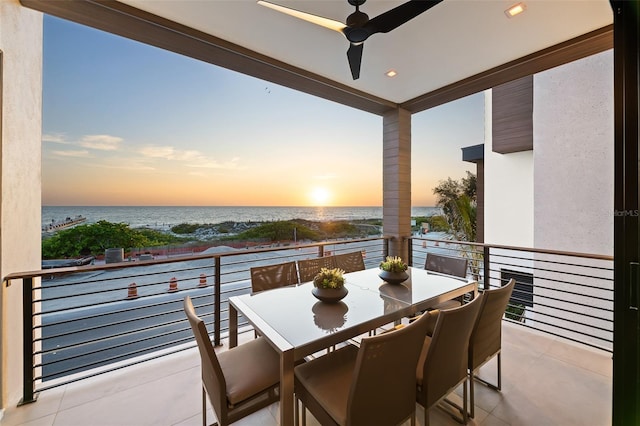 100 6th St S, Bradenton Beach, FL 34217 - balcony at dusk featuring a ceiling fan, a water view, and outdoor dining space