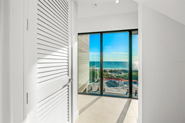 100 6th St S, Bradenton Beach, FL 34217 - doorway to outside with a water view and tile patterned flooring