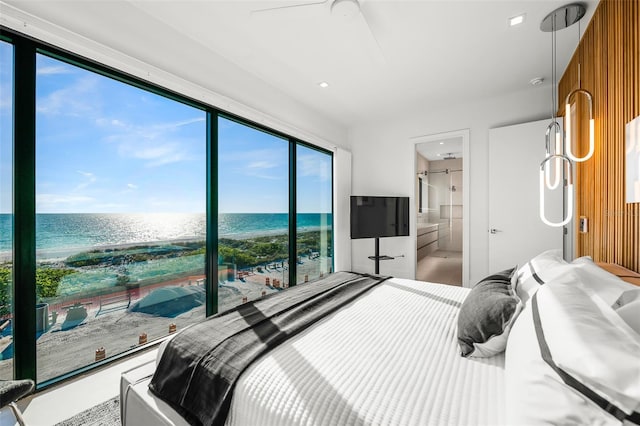100 6th St S, Bradenton Beach, FL 34217 - bedroom featuring view of water and beach, ensuite bathroom, and a ceiling fan