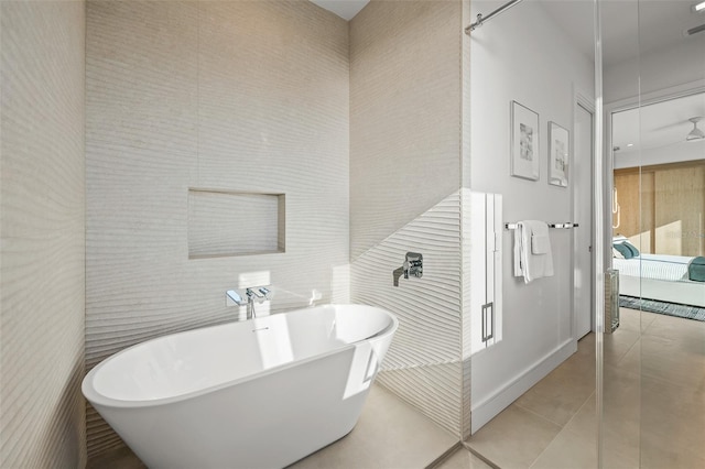 100 6th St S, Bradenton Beach, FL 34217 - bathroom with a soaking tub, tile patterned floors, and tile walls