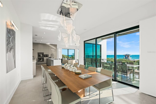 100 6th St S, Bradenton Beach, FL 34217 - dining room with a water view, recessed lighting, and baseboards
