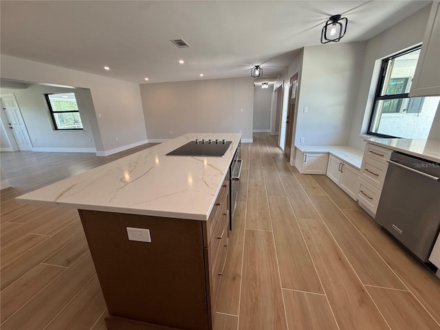 808 25th Ave W, Palmetto, FL 34221 - kitchen featuring stainless steel dishwasher, black electric stovetop, light wood-type flooring, open floor plan, and recessed lighting