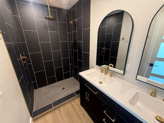 808 25th Ave W, Palmetto, FL 34221 - full bathroom with double vanity, a tile shower, and wood finished floors