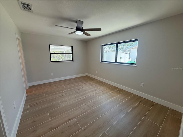 808 25th Ave W, Palmetto, FL 34221 - spare room with wood finished floors, ceiling fan, and baseboards