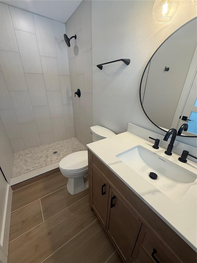 808 25th Ave W, Palmetto, FL 34221 - bathroom featuring vanity, a stall shower, toilet, and wood finished floors
