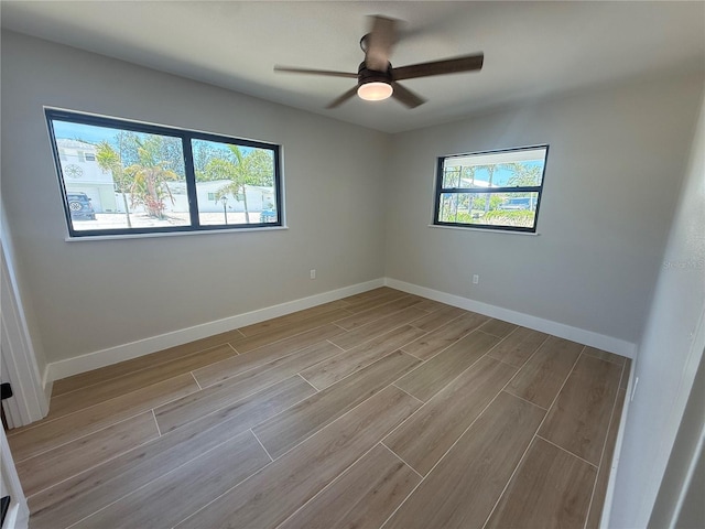 808 25th Ave W, Palmetto, FL 34221 - spare room with wood finished floors, a ceiling fan, and baseboards