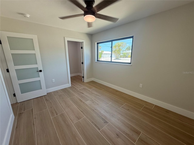 808 25th Ave W, Palmetto, FL 34221 - unfurnished bedroom with wood finished floors, baseboards, a walk in closet, a closet, and ceiling fan