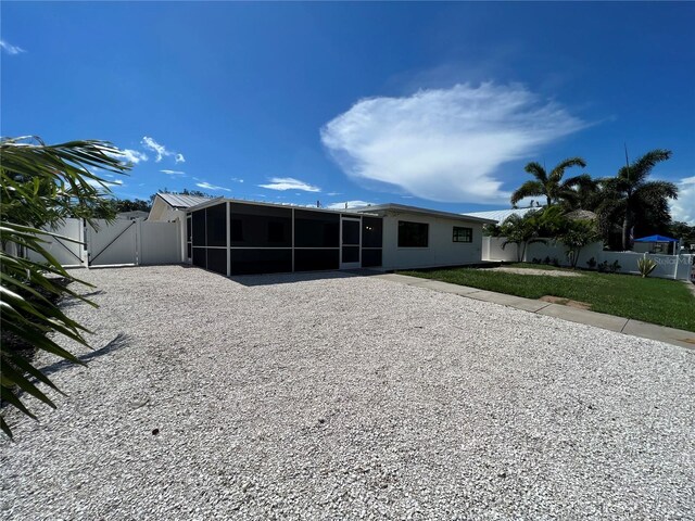 808 25th Ave W, Palmetto, FL 34221 - rear view of house with a sunroom and a gate
