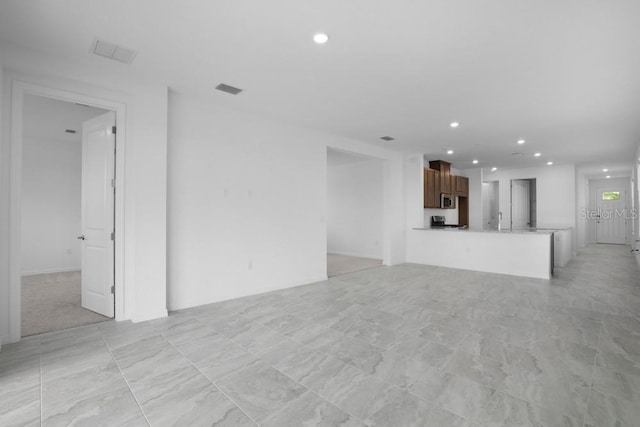8632 Snowfall St, Sarasota, FL 34241 - unfurnished living room with recessed lighting