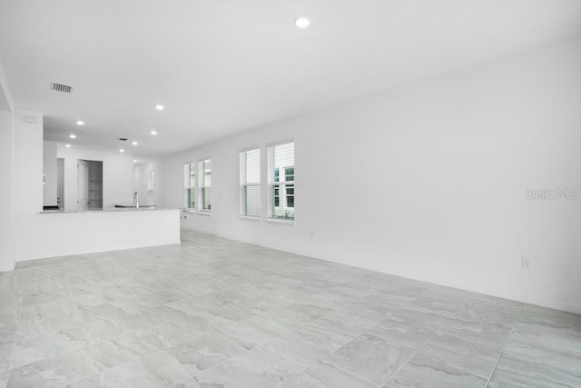 8632 Snowfall St, Sarasota, FL 34241 - unfurnished living room featuring recessed lighting