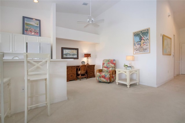 5330 Hyland Hills Ave Unit 2324, Sarasota, FL 34241 - sitting room featuring light colored carpet, a ceiling fan, a desk, a high ceiling, and baseboards