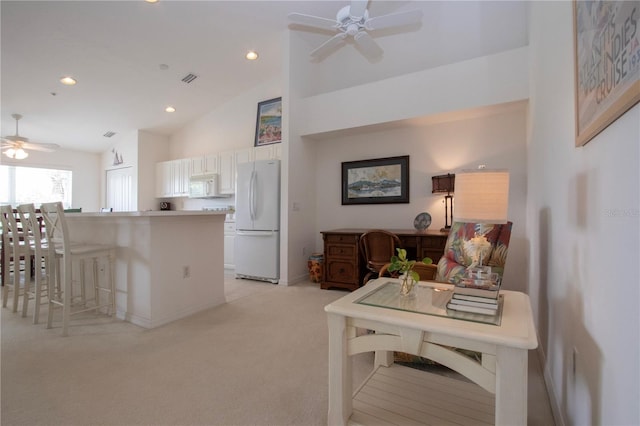 5330 Hyland Hills Ave Unit 2324, Sarasota, FL 34241 - kitchen featuring white appliances, ceiling fan, light carpet, white cabinets, and high vaulted ceiling