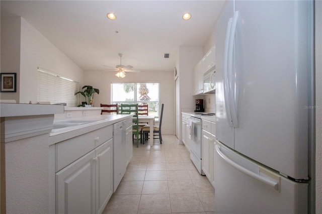 5330 Hyland Hills Ave Unit 2324, Sarasota, FL 34241 - kitchen with white appliances, ceiling fan, white cabinetry, vaulted ceiling, and light countertops