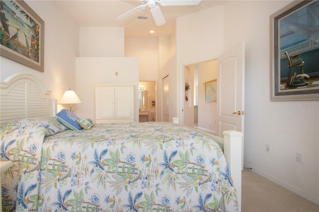 5330 Hyland Hills Ave Unit 2324, Sarasota, FL 34241 - carpeted bedroom featuring a towering ceiling, baseboards, a ceiling fan, and ensuite bath