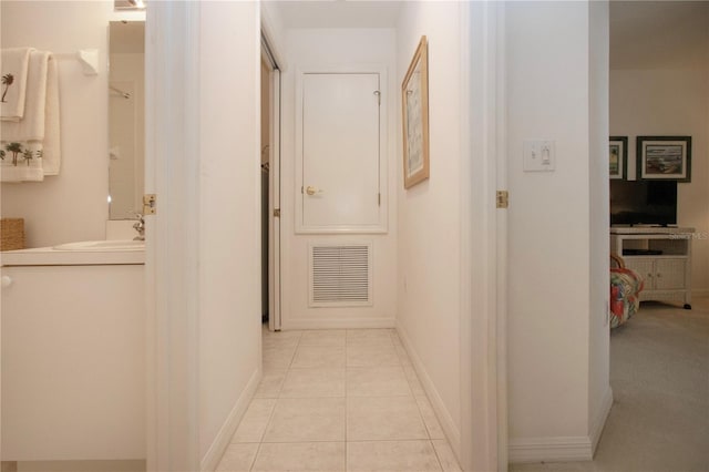 5330 Hyland Hills Ave Unit 2324, Sarasota, FL 34241 - corridor featuring a sink, light tile patterned floors, and baseboards