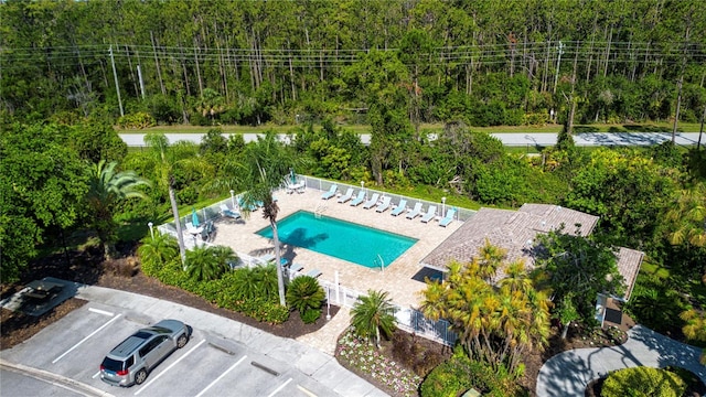 5330 Hyland Hills Ave Unit 2324, Sarasota, FL 34241 - drone / aerial view of a pool area and a heavily wooded area