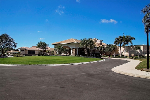 5330 Hyland Hills Ave Unit 2324, Sarasota, FL 34241 - view of front of home featuring a front lawn, a residential view, and stucco siding