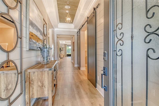 1919 Woodleaf Hammock Ct, Bradenton, FL 34211 - corridor with a barn door, ornamental molding, light wood finished floors, and a raised ceiling