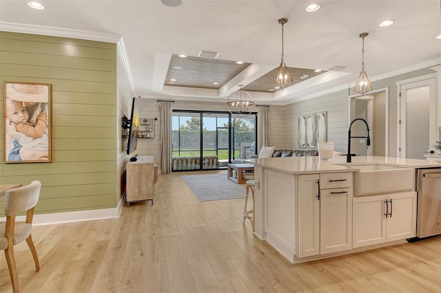 1919 Woodleaf Hammock Ct, Bradenton, FL 34211 - kitchen featuring stainless steel dishwasher, a tray ceiling, open floor plan, a sink, and a chandelier
