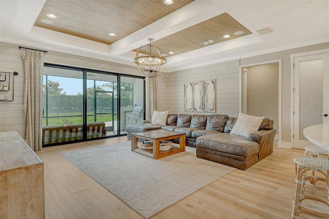 1919 Woodleaf Hammock Ct, Bradenton, FL 34211 - living room with a raised ceiling, light wood-style flooring, a chandelier, recessed lighting, and crown molding