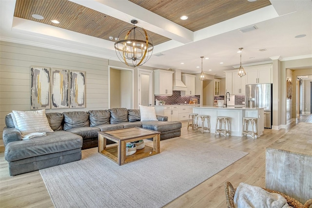 1919 Woodleaf Hammock Ct, Bradenton, FL 34211 - living area with a chandelier, light wood-type flooring, a raised ceiling, recessed lighting, and crown molding